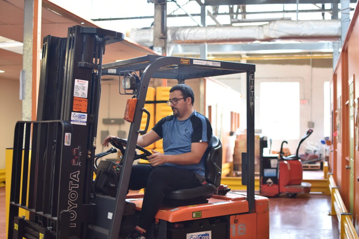 A participant in North York Harvest’s Leadership in Logistics program receives forklift training. Photo: North York Harvest Food Bank